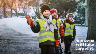 Day care aged children are walking in a snowy landscape, led by an adult. Only the glove-covered hand of the adult is visible. The text on the image reads "Someone will take care of it."