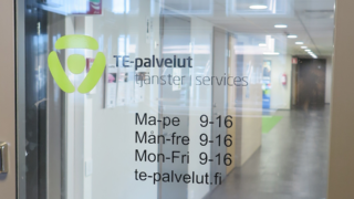 A glass door at TE services with the TE office opening hours.